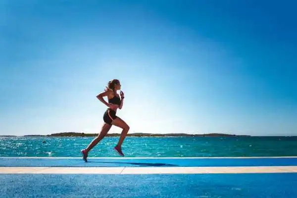 Woman running showing strong leg muscle Cirencester